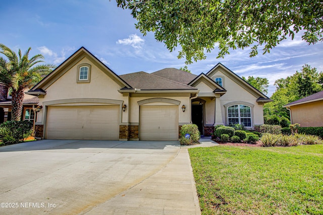 1911 Salt Creek Dr, Fleming Island, FL 32003 - view of front of house with a front lawn, concrete driveway, a garage, a shingled roof, and stucco siding