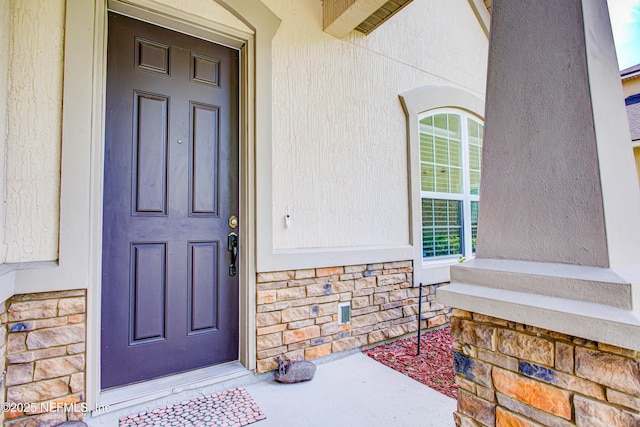 1911 Salt Creek Dr, Fleming Island, FL 32003 - doorway to property featuring stone siding and covered porch