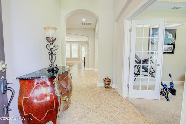1911 Salt Creek Dr, Fleming Island, FL 32003 - corridor with arched walkways, visible vents, baseboards, and light tile patterned floors