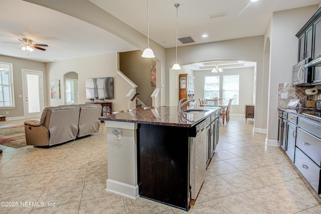 1911 Salt Creek Dr, Fleming Island, FL 32003 - kitchen with ceiling fan, arched walkways, a sink, and light tile patterned floors