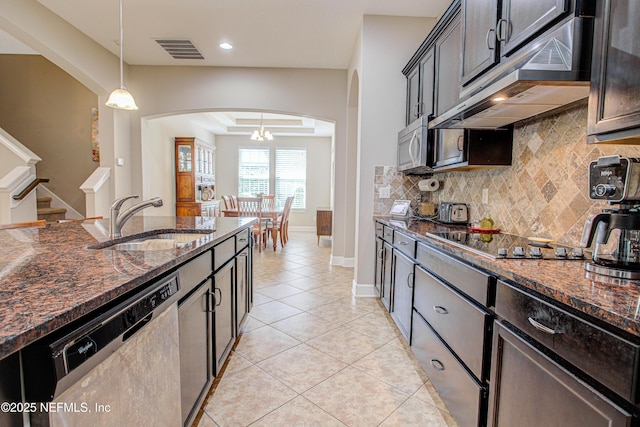 1911 Salt Creek Dr, Fleming Island, FL 32003 - kitchen featuring under cabinet range hood, visible vents, a sink, arched walkways, and appliances with stainless steel finishes
