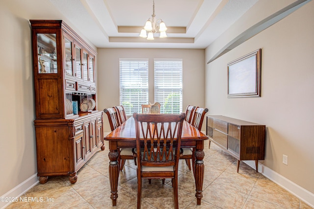 1911 Salt Creek Dr, Fleming Island, FL 32003 - dining room with baseboards, a tray ceiling, a notable chandelier, and light tile patterned floors