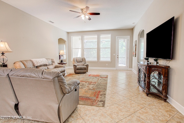 1911 Salt Creek Dr, Fleming Island, FL 32003 - living room featuring arched walkways, baseboards, visible vents, a ceiling fan, and light tile patterned floors