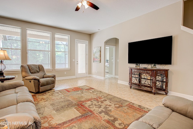 1911 Salt Creek Dr, Fleming Island, FL 32003 - tiled living area with arched walkways, a ceiling fan, and baseboards