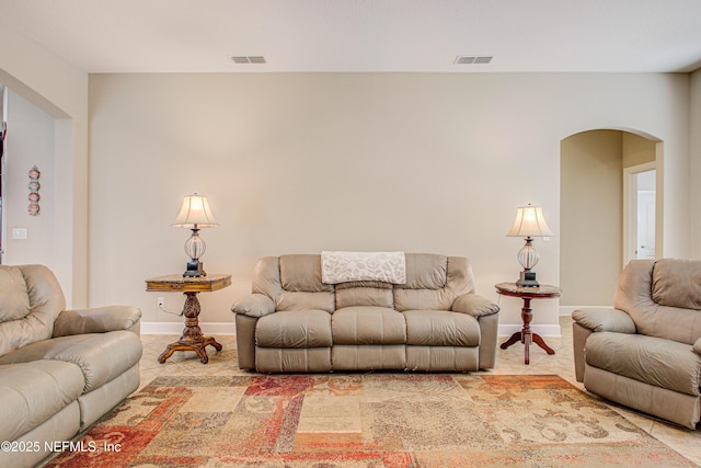 1911 Salt Creek Dr, Fleming Island, FL 32003 - living area with arched walkways, visible vents, and baseboards