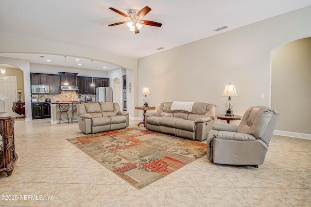 1911 Salt Creek Dr, Fleming Island, FL 32003 - living area with light tile patterned floors, arched walkways, and ceiling fan
