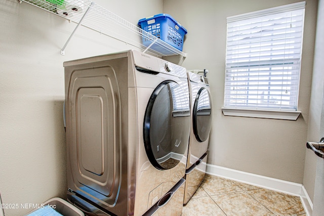 1911 Salt Creek Dr, Fleming Island, FL 32003 - laundry area featuring washer and dryer, baseboards, tile patterned floors, and laundry area