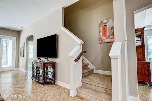 1911 Salt Creek Dr, Fleming Island, FL 32003 - stairs with arched walkways, baseboards, and tile patterned floors