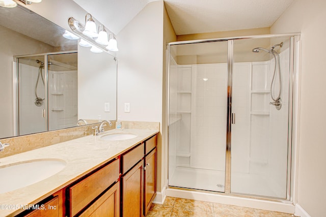1911 Salt Creek Dr, Fleming Island, FL 32003 - bathroom featuring tile patterned flooring, a sink, double vanity, and a stall shower