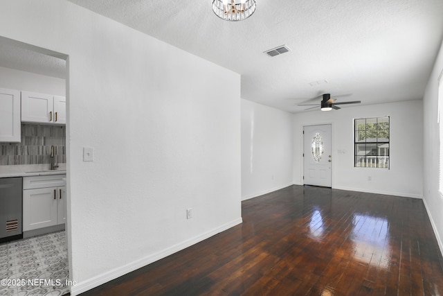 5246 Sunderland Rd, Jacksonville, FL 32210 - unfurnished living room with a sink, baseboards, visible vents, ceiling fan with notable chandelier, and hardwood / wood-style flooring