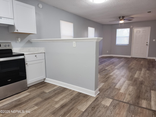 860 Westbrook Rd, Jacksonville, FL 32209 - kitchen featuring stainless steel electric range, under cabinet range hood, a peninsula, and white cabinets