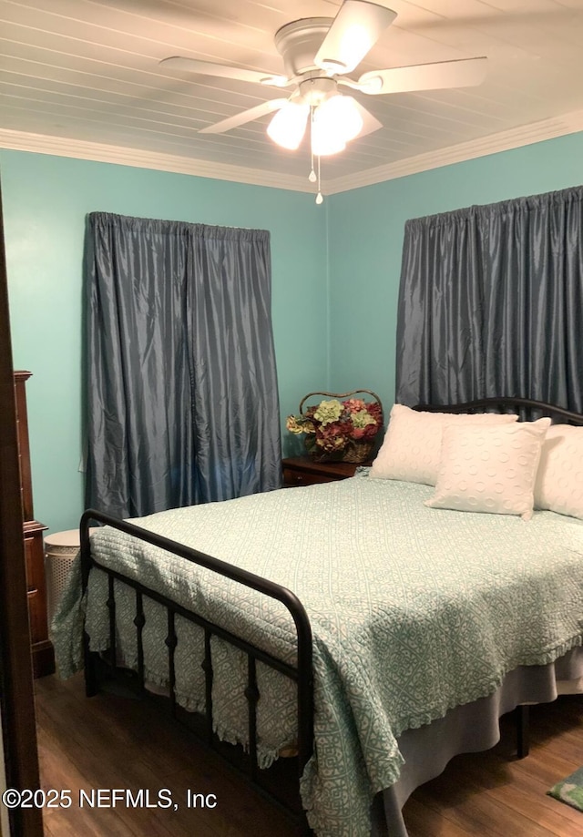 bedroom featuring ornamental molding, a ceiling fan, and wood finished floors