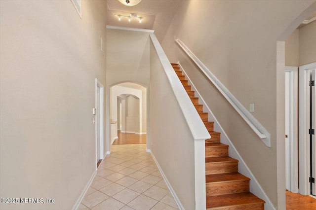 13644 Goodson Pl, Jacksonville, FL 32226 - stairs featuring track lighting, arched walkways, and tile patterned floors