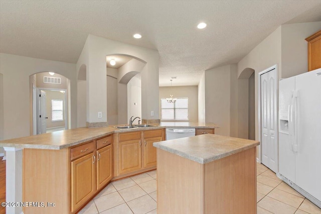 13644 Goodson Pl, Jacksonville, FL 32226 - kitchen with a sink, white appliances, light countertops, visible vents, and a kitchen island