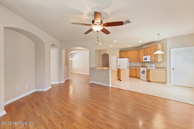 13644 Goodson Pl, Jacksonville, FL 32226 - unfurnished living room featuring arched walkways, visible vents, light wood finished floors, and ceiling fan