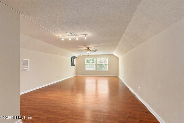 13644 Goodson Pl, Jacksonville, FL 32226 - bonus room featuring a textured ceiling, vaulted ceiling, visible vents, wood finished floors, and ceiling fan