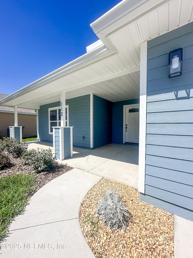 112 Moseley Ave, Palatka, FL 32177 - doorway to property featuring an attached carport and a porch