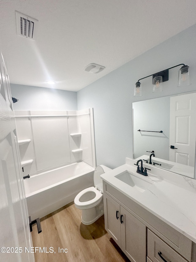 112 Moseley Ave, Palatka, FL 32177 - full bathroom with wood finished floors, vanity, toilet, and bathtub / shower combination