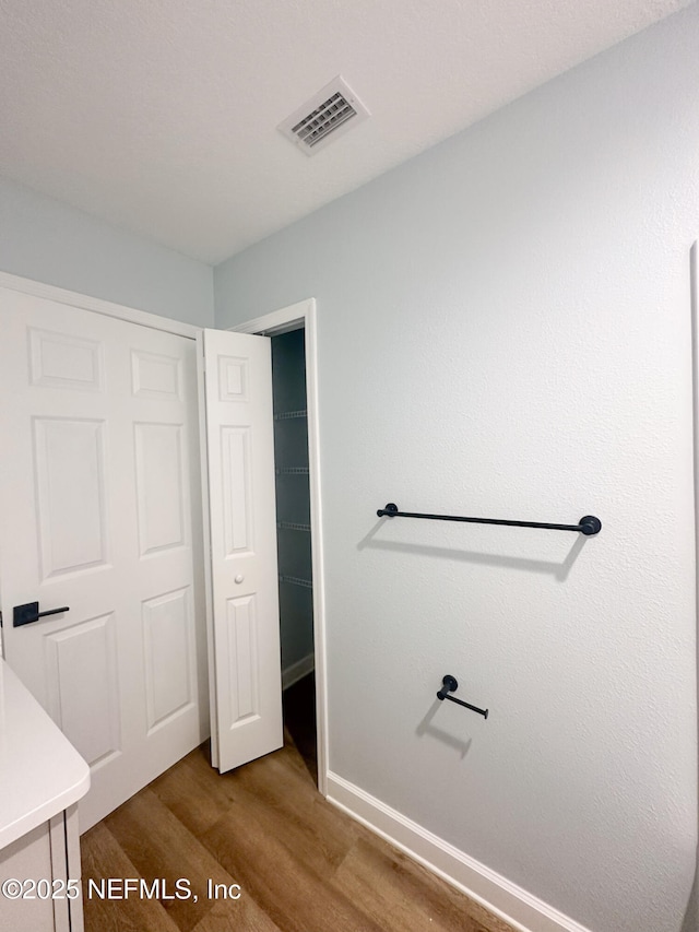 112 Moseley Ave, Palatka, FL 32177 - bathroom with wood finished floors, baseboards, and vanity