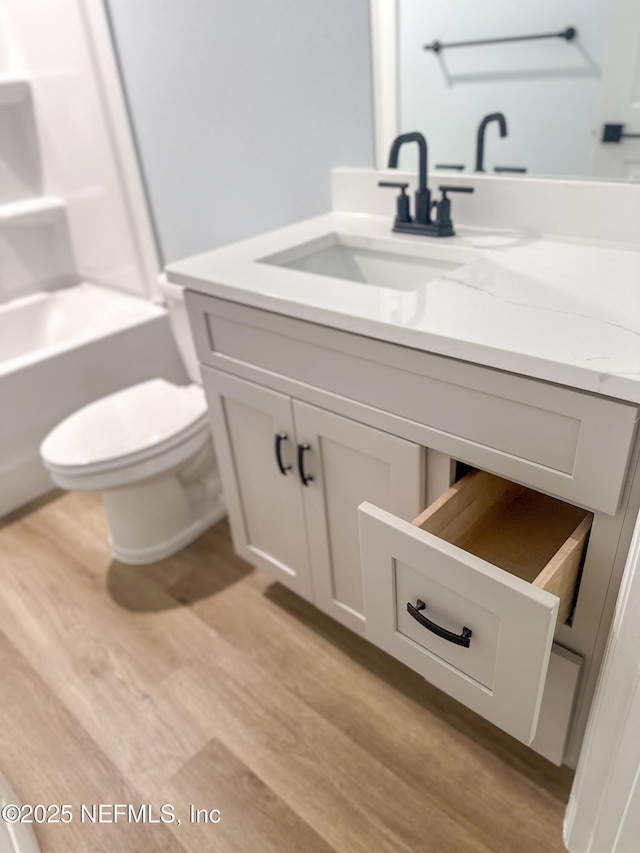 112 Moseley Ave, Palatka, FL 32177 - full bathroom with vanity, wood finished floors, toilet, and  shower combination