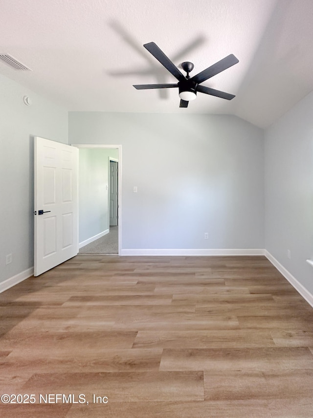 112 Moseley Ave, Palatka, FL 32177 - spare room featuring a ceiling fan, baseboards, vaulted ceiling, and wood finished floors