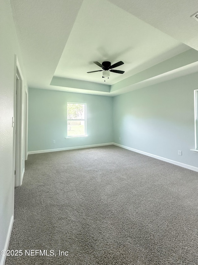 112 Moseley Ave, Palatka, FL 32177 - unfurnished room featuring a raised ceiling, baseboards, and a ceiling fan