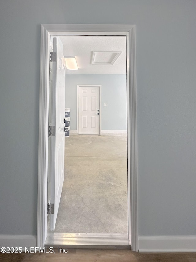 112 Moseley Ave, Palatka, FL 32177 - hallway featuring baseboards and attic access