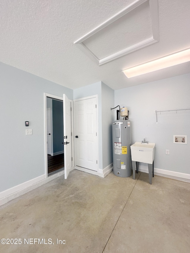 112 Moseley Ave, Palatka, FL 32177 - garage with electric water heater, a sink, and baseboards