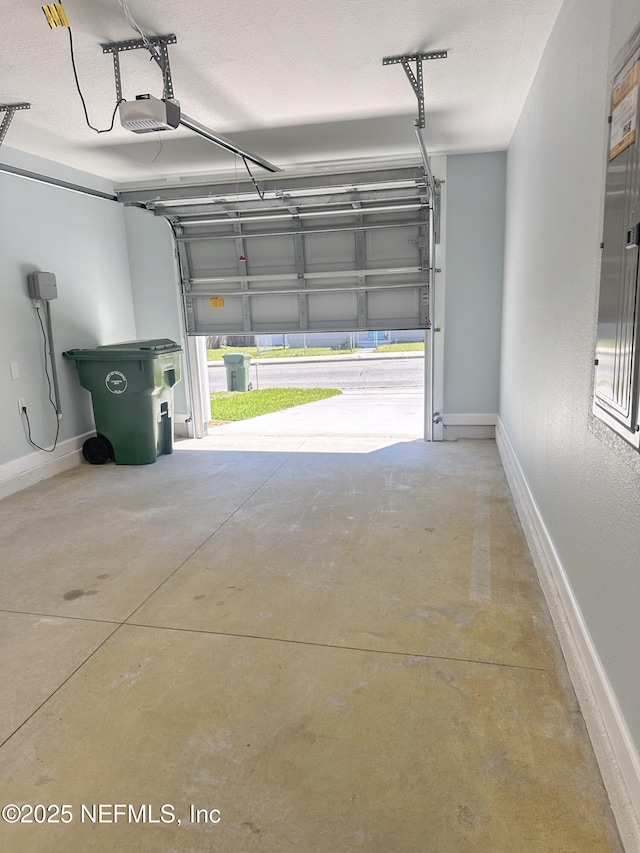 112 Moseley Ave, Palatka, FL 32177 - garage featuring a garage door opener and baseboards