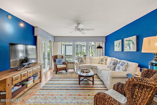 living area featuring light tile patterned floors and ceiling fan