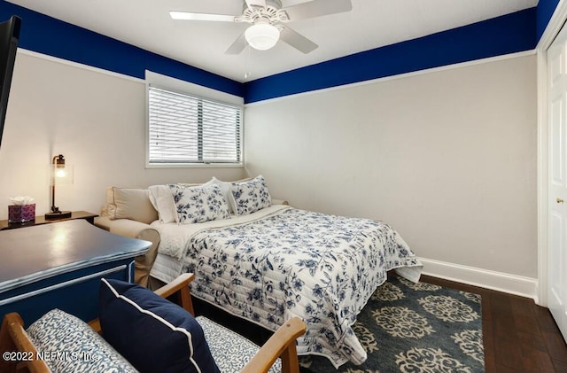 bedroom featuring baseboards, ceiling fan, and wood finished floors