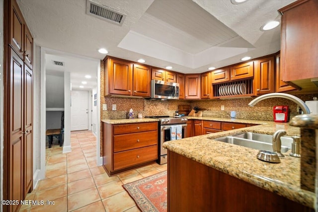 272 Deer Run Ln, Ponte Vedra Beach, FL 32082 - kitchen featuring appliances with stainless steel finishes, a sink, light tile patterned flooring, decorative backsplash, and recessed lighting