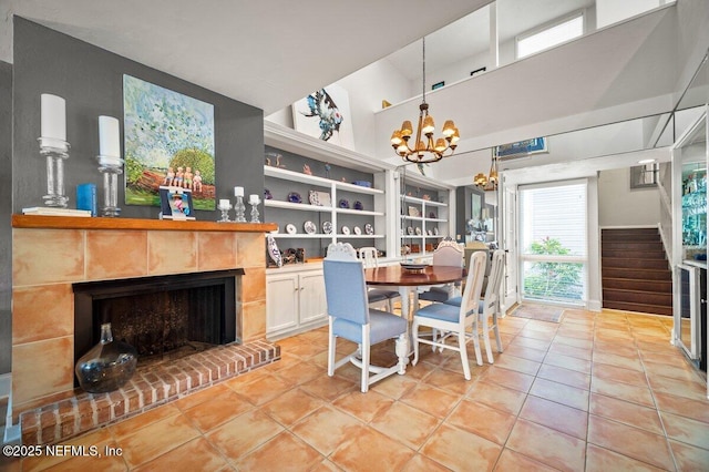 272 Deer Run Ln, Ponte Vedra Beach, FL 32082 - dining room featuring light tile patterned flooring, a chandelier, a towering ceiling, stairway, and a fireplace with raised hearth