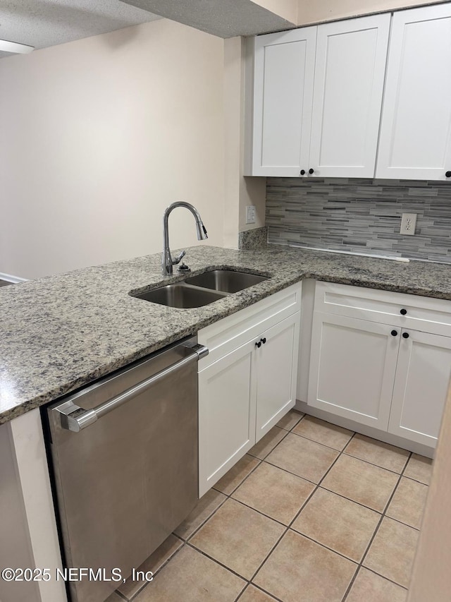 5006 Knightsbridge Cir N, Jacksonville, FL 32244 - kitchen with light tile patterned flooring, dishwasher, white cabinetry, and a sink