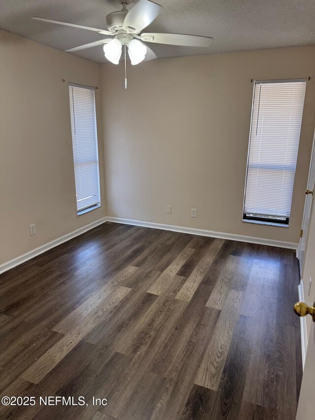 5006 Knightsbridge Cir N, Jacksonville, FL 32244 - spare room featuring ceiling fan, baseboards, dark wood-style flooring, and a wealth of natural light