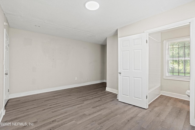 5741 Castellano Ave, Jacksonville, FL 32208 - unfurnished bedroom with wood finished floors and baseboards