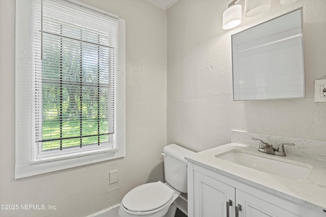 5741 Castellano Ave, Jacksonville, FL 32208 - half bathroom with toilet, vanity, and a textured wall