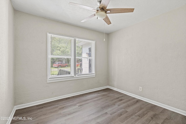 5741 Castellano Ave, Jacksonville, FL 32208 - spare room with wood finished floors, a ceiling fan, and baseboards