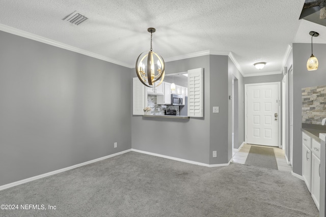 unfurnished dining area featuring ornamental molding, visible vents, light carpet, and a textured ceiling