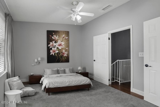 bedroom featuring baseboards, ceiling fan, dark colored carpet, and visible vents