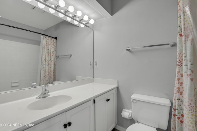 full bathroom with toilet, curtained shower, and vanity