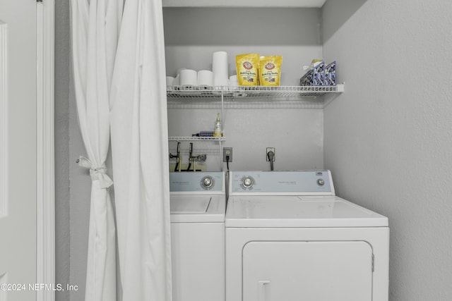 laundry area with washing machine and clothes dryer and laundry area