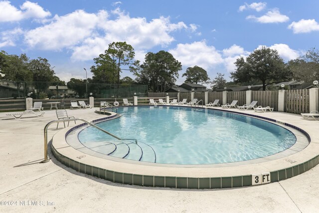 pool featuring a patio and fence