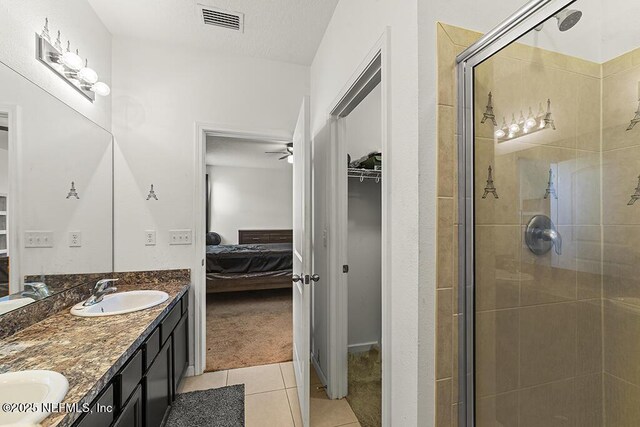 3410 Ridgeview Dr, Green Cove Springs, FL 32043 - ensuite bathroom with tile patterned floors, a shower stall, double vanity, and ceiling fan