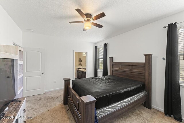 3410 Ridgeview Dr, Green Cove Springs, FL 32043 - bedroom featuring light carpet, a textured ceiling, connected bathroom, a ceiling fan, and baseboards