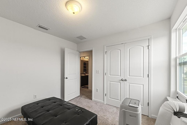 3410 Ridgeview Dr, Green Cove Springs, FL 32043 - bedroom featuring light colored carpet, a textured ceiling, a closet, and baseboards
