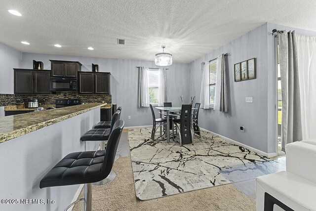 3410 Ridgeview Dr, Green Cove Springs, FL 32043 - dining area with baseboards, recessed lighting, a textured ceiling, and a chandelier