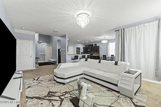 3410 Ridgeview Dr, Green Cove Springs, FL 32043 - living area with a chandelier, light colored carpet, a textured ceiling, and arched walkways