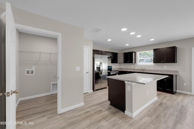 12171 Calais St, Jacksonville, FL 32224 - kitchen featuring light wood-type flooring, baseboards, recessed lighting, a kitchen island, and appliances with stainless steel finishes