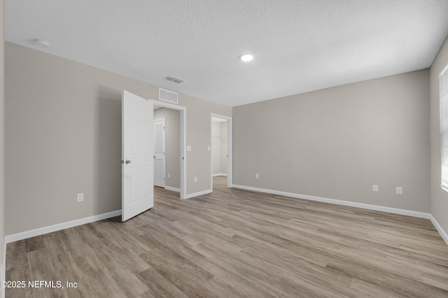 12171 Calais St, Jacksonville, FL 32224 - spare room with baseboards, light wood-style flooring, visible vents, and a textured ceiling